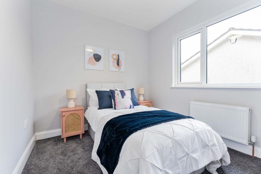 epic property staging bedroom with pink bedside cabinets
